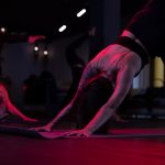 yoga übung in der gruppe ausgeführt in toller Location abgedunkelt